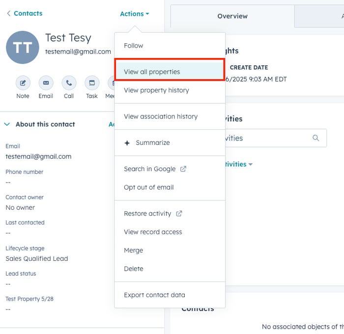 This is a HubSpot contact record for "Test Tesy" with an open Actions dropdown menu displaying various contact management options including "View all properties" (highlighted in red), "View property history," "Summarize," "Search in Google," and other actions like merge, delete, and export. The left side shows the contact's basic information including email, phone number, contact owner, and lifecycle stage as "Sales Qualified Lead."