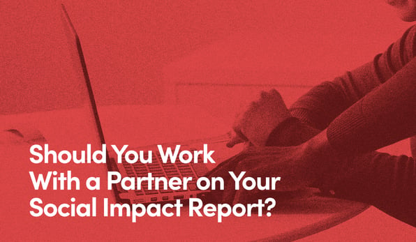 Close up of two people operating laptop with text - Should you work with a partner on yours social impact report