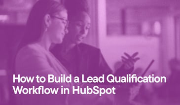 How to Build a Lead Qualification Workflow in HubSpot overlayed on an image of two women looking at a tablet together.