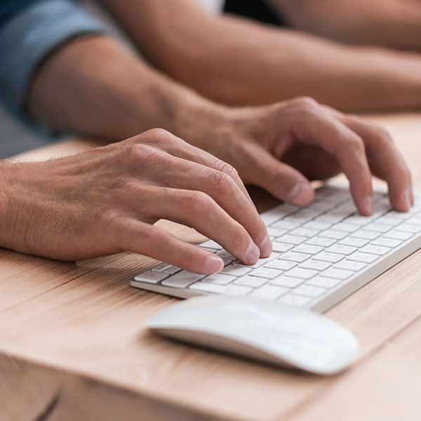 Hands typing on keyboard