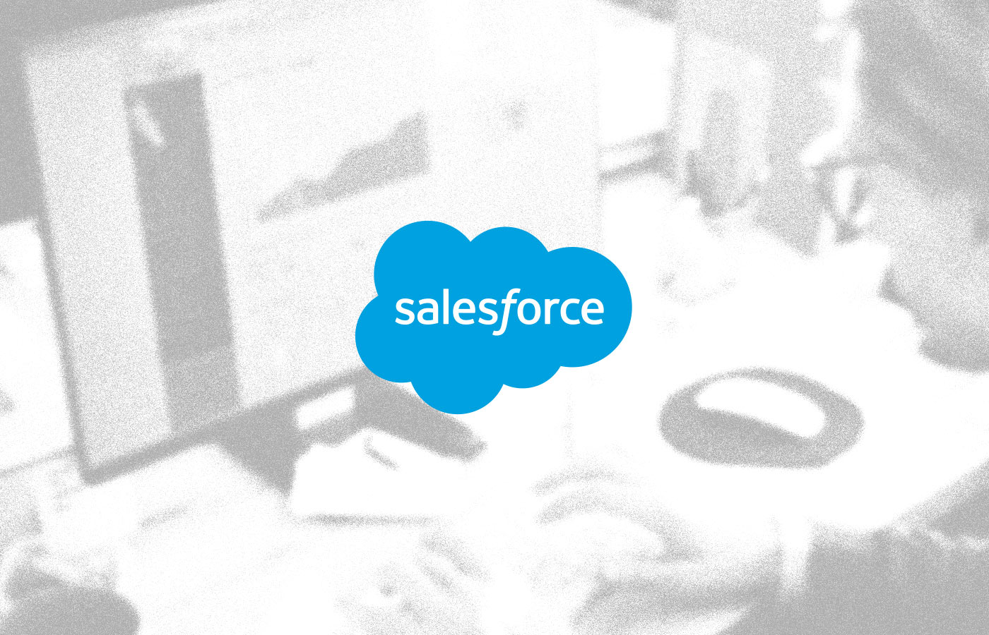 Salesforce logo overlayed on an image of someone working at a computer