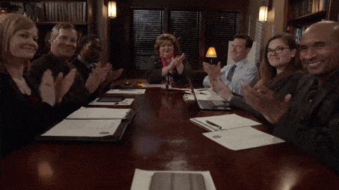 A conference room full of people clapping