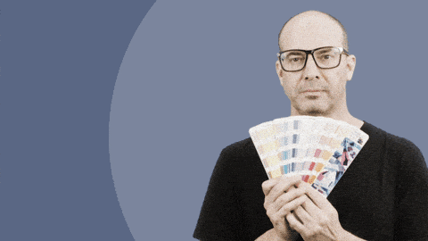 A man holding a Pantone swatch book saying, 'Don't take that tone with me'