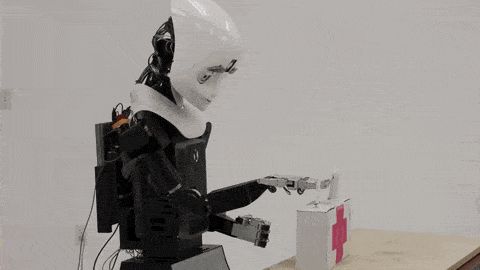 A robot picking up a box and moving it