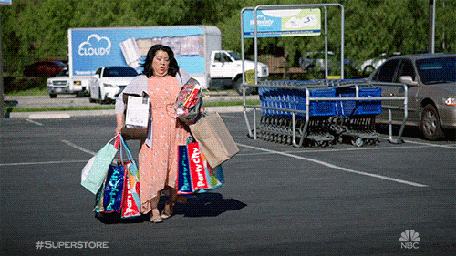 A woman struggling with a lot of shopping bags