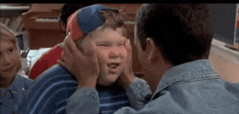 Adam Sandler as Billy Madison shaking a kid’s face