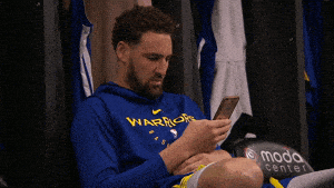 Basketball player Klay Thompson scrolling on his phone