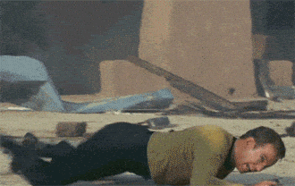 Captain Kirk crawling on the ground.