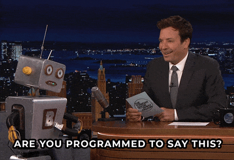 Jimmy Fallon talking to a robot saying 'are you programmed to say this?'