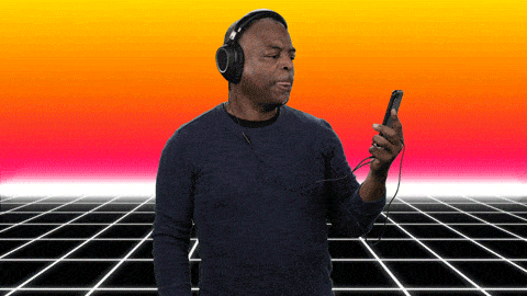 Levar Burton wearing headphones listening to something on his phone saying, 'you gotta hear this.'