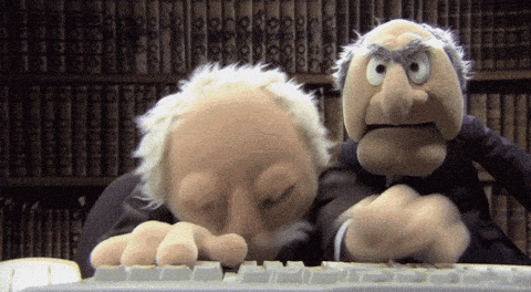 Muppets Statler and Waldorf typing fervently on a keyboard