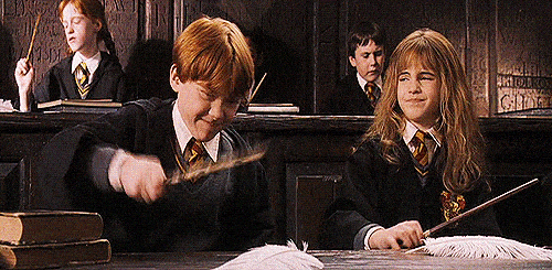 Ron Weasley waving his wand erratically trying to levitate a feather