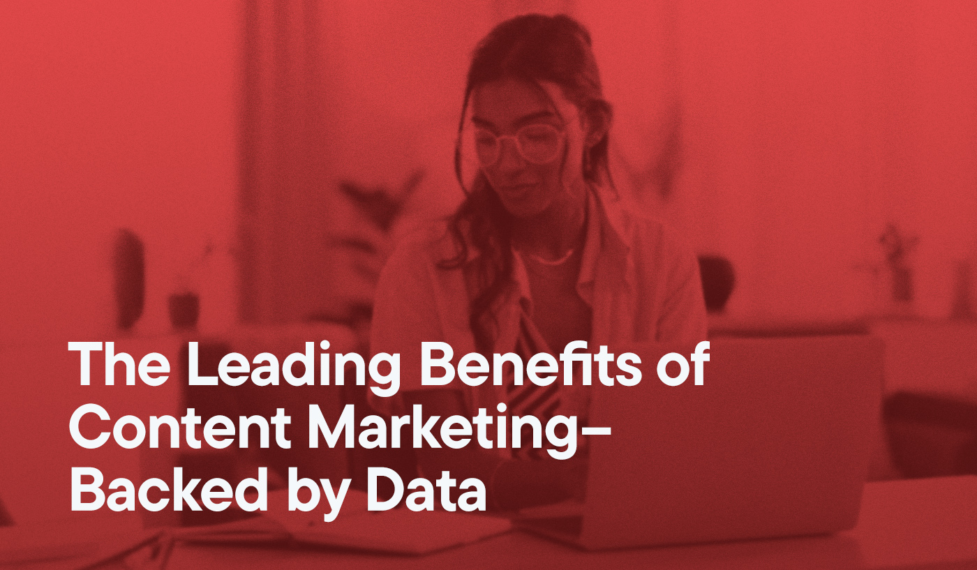 The Leading Benefits of Content Marketing–Backed by Data overlayed on an image of a woman typing on her laptop.