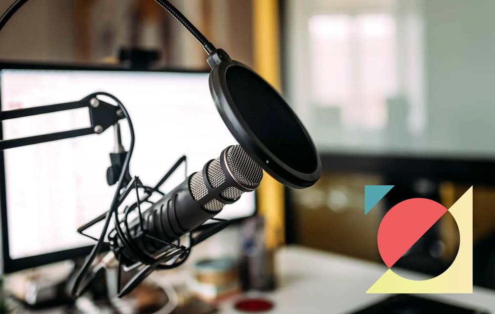 Microphone in front of computer in podcast studio