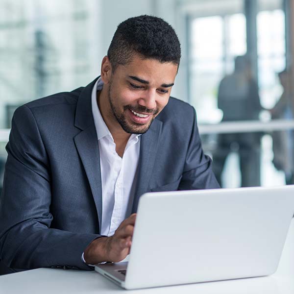 Man works on laptop in corporate office